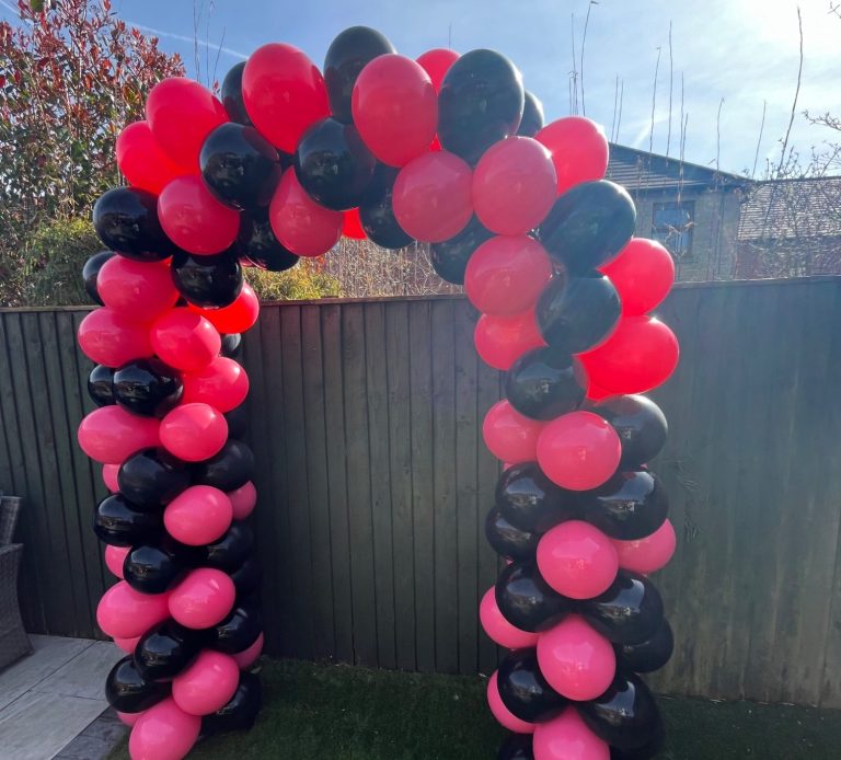 A decorative arch made of pink, and black balloons.